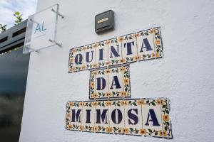 a sign on the side of a building with tiles on it at Quinta da Mimosa in Amieira