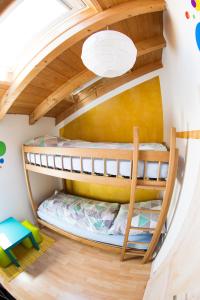 a room with two bunk beds in a house at Hinterlechnerhof in Rimsting