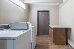 a kitchen with a white counter and a door at GreenRidge Hotel in Wickliffe