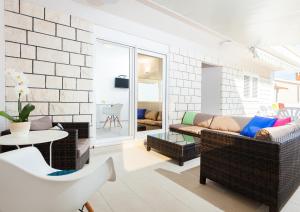 a living room with a couch and a table at Apartments Gita in Zavalatica