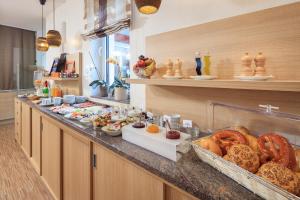 a buffet line with a lot of food on it at Hotel Schönau in Lindau