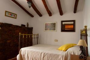 A bed or beds in a room at La Rana Verde Casa Rural