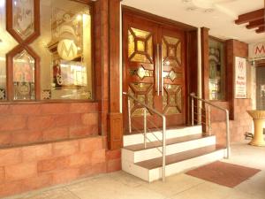 a store front with stairs in front of a door at Hotel Mayfair in Lahore