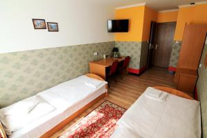 Postel nebo postele na pokoji v ubytování FusGym Resort