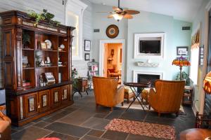a living room with two chairs and a table at The Richard Johnston Inn & 1890 Caroline House in Fredericksburg