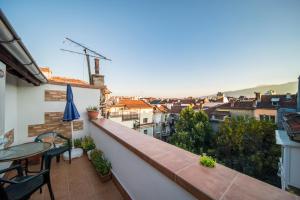 a balcony with a table and a view of a city at Sunny Apartment Sofia in Sofia