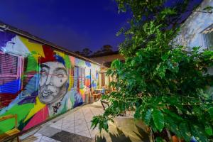 a wall with a painting of a man on it at The Gallery Floripa in Florianópolis