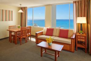 a living room with a couch and a table at Pacific Monarch Hotel in Honolulu