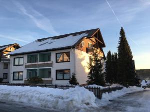 een huis met een met sneeuw bedekt dak bij Ferienwohnung MILA Braunlage in Braunlage