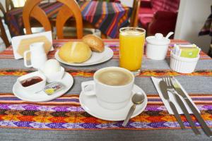 a table with a cup of coffee and a plate of food at Casa Rodas in Lima