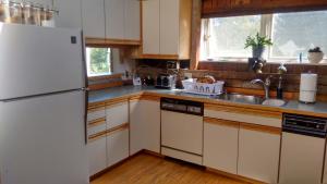 a kitchen with a white refrigerator and a sink at Lodge at Millstone Hill in Barre