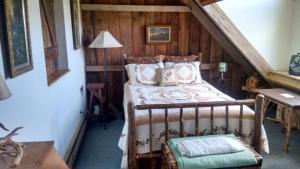 a bedroom with a bed in a attic at Lodge at Millstone Hill in Barre