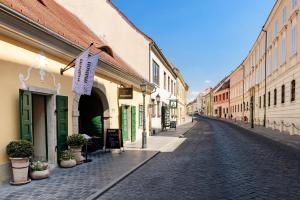 an empty street in an old town with buildings at Maison Bistro & Hotel in Budapest