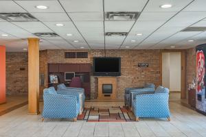 a lobby with chairs and a television in a building at Motel 6-Grand Rapids, MI - Northeast in Grand Rapids