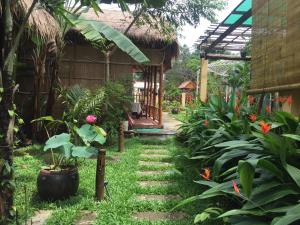 a garden with a bench and some plants at Tropical Garden Phu Quoc in Phú Quốc