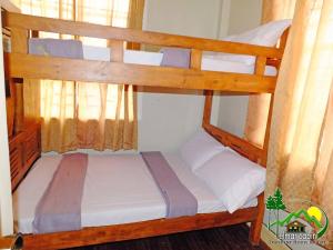 a couple of bunk beds in a room at Elmar Cabin in Baguio