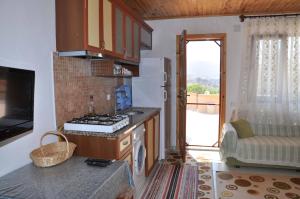 a kitchen with a stove and a refrigerator at Jet Pension in Patara