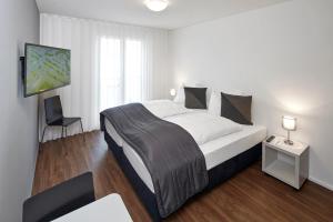 Postel nebo postele na pokoji v ubytování Aparthotel Baden + 31 fotografií