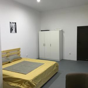 a bedroom with a bed and a black and white picture at Central Park Studios in Bucharest +101 photos