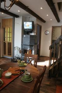 une salle à manger avec une table en bois et une télévision dans l'établissement Vuokatin Aateli Ritari & Lady, à Vuokatti