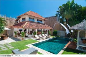 a house with a swimming pool in a yard at 3BR Villa Rabu - Minggu Villas Seminyak in Seminyak
