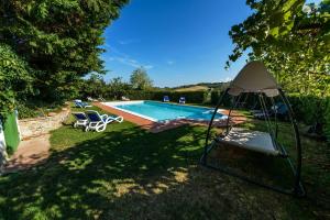 a swimming pool with a gazebo in a yard at Agriturismo Olmi Grossi in Impruneta