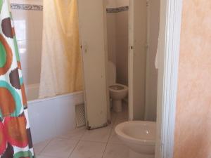 a bathroom with a toilet and a sink at Hotel Le Gardenia (ex Lutetia) in Tangier