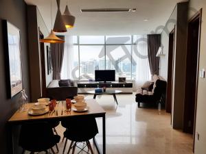 a living room with a table and chairs and a television at 5 STAR & LUXURY Apartment near KLCC/ KL City Centre in Kuala Lumpur
