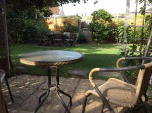 a table and two chairs in a yard at Cavell House Bed and Breakfast in Clevedon