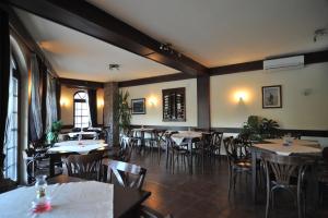 a restaurant with tables and chairs in a room at Apartments Via Sakra in Ohrid