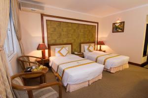 Postel nebo postele na pokoji v ubytování Palace Hotel Vung Tau
