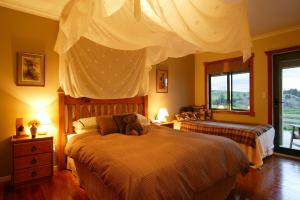 a bedroom with two beds with a teddy bear on it at Abseil Inn in Waitomo Caves