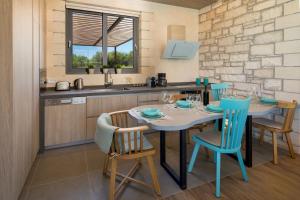 a kitchen with a table and chairs in a kitchen at Titans Villas in Kókkinon Khoríon