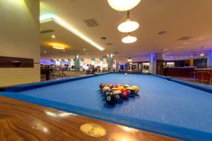 a pool table with balls on top of it at Hotel Grand Swiss in Erbil