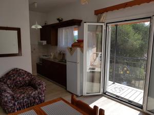 a kitchen with a refrigerator and a kitchen with a balcony at Maria's Paradise in Astrakeri
