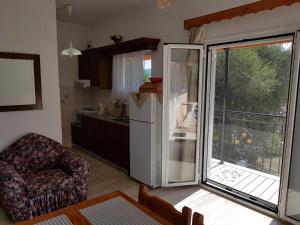 a kitchen with a refrigerator and a kitchen with a balcony at Maria's Paradise in Astrakeri +82 photos