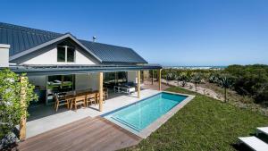 an image of a house with a swimming pool at Willow Beach House - with backup power in Noordhoek