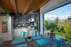 a kitchen with a table and chairs on a balcony at APARTMANY L&O - Laura in Zvolenské Nemce