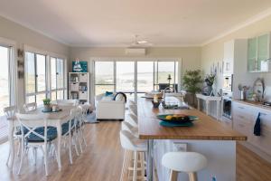 a kitchen and living room with a table and chairs at Shades of Blue Eco Retreat in Calca