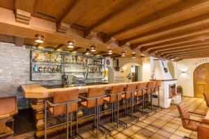 a bar in a restaurant with a bunch of stools at Hotel Garni Birkenhof in Sölden
