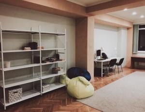 a room with white shelves and a table and a desk at Hostel on Komsomolskaya in Sochi