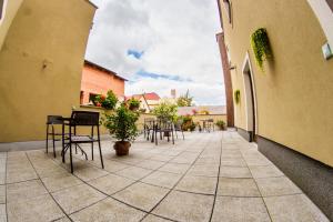 a patio with tables and chairs in a building at Penzion Černej pták in Jindrichuv Hradec