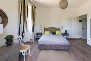 a bedroom with a bed with yellow pillows at Casale Virginia in Cesariano