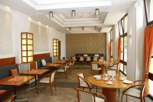 a dining room with wooden tables and chairs at Hotel Haus Hohenstein in Witten