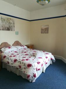 a bedroom with a bed and a dresser at Cavendish House in Weymouth