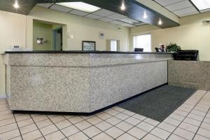 a lobby with a reception counter in an office at Americas Best Value Inn Florida Turnpike & I-95 in Fort Pierce