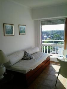 a bed in a room with a large window at Panoramico Playa Grande -Solo Familias in Mar del Plata