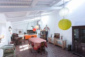 a living room with a table and chairs and lights at Quinta do Paraizo in Ribeira Grande