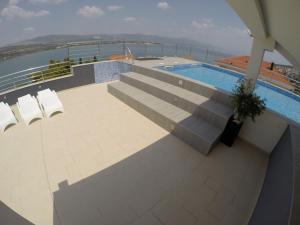 a swimming pool on top of a building at Apartments Exclusive Palace in Trogir
