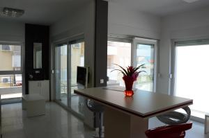 a kitchen with a table, chairs, and a window at Apartments Exclusive Palace in Trogir